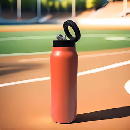 gourde orange posee sur piste athletisme