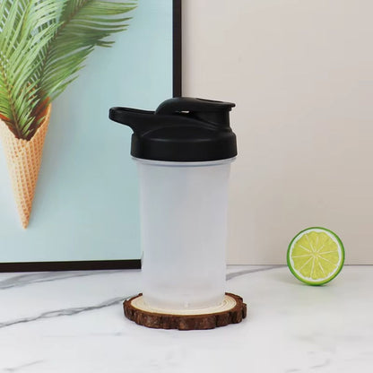 shaker protéine noir en présentation à côté rondelle citron vert et plante